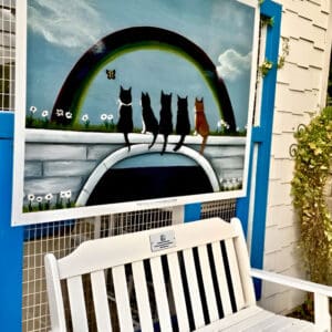 A bench sitting in front of a painting.