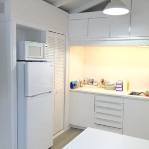 A white refrigerator and microwave in a kitchen.