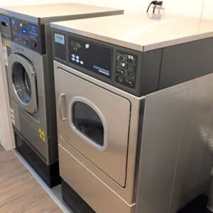 A pair of washing machines in a room.